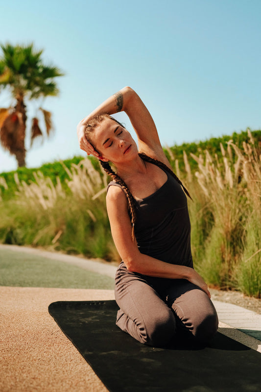 Women wearing Tencel Jumpsuit doing Yoga at the beach