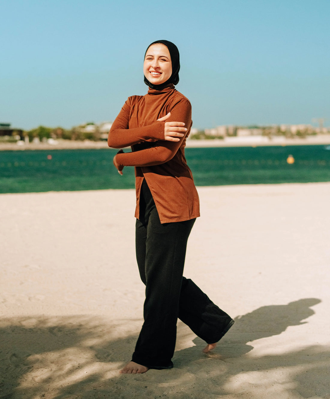 Women in Tencel modest top running on the beach in GCC