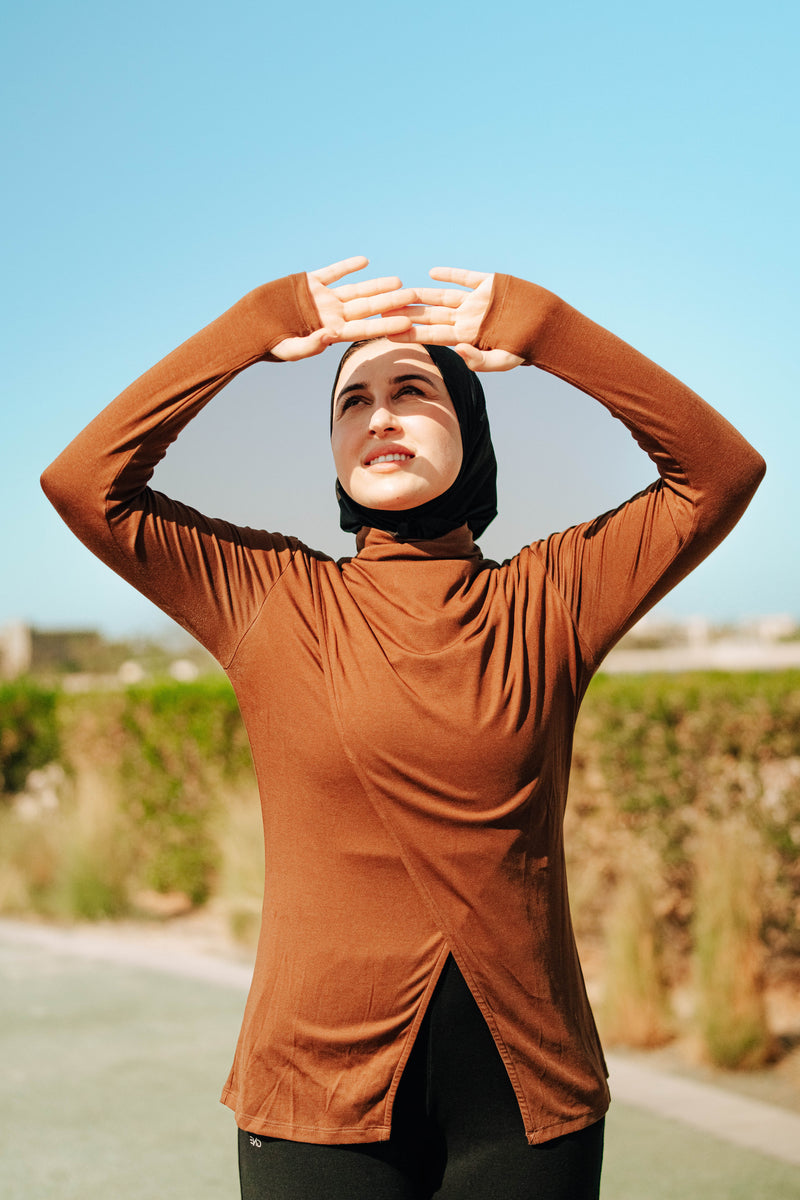 Women in long-sleeve modest top with a hijab,  made from Tencel natural fibre for outdoor workouts 