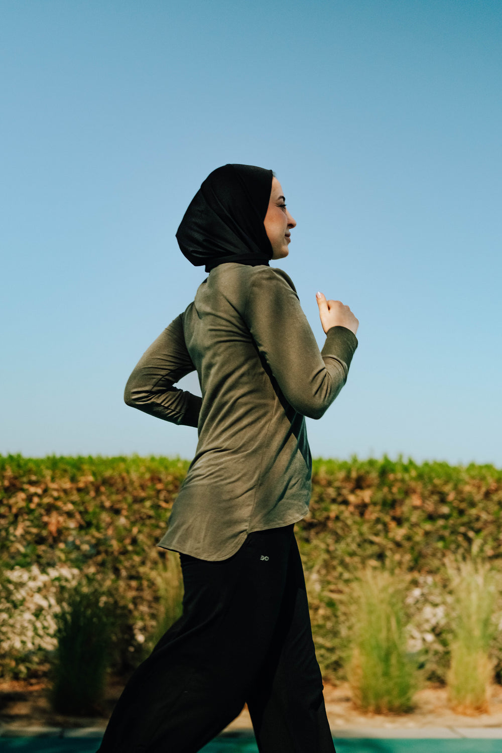 Woman running in modest, Tencel and Organic cotton activewear In UAE