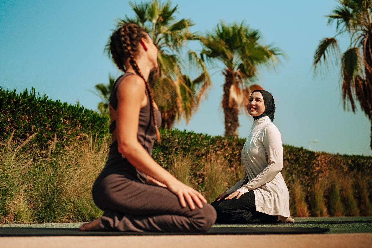 Two women practicing yoga in Tencel Natural fibre activewear In GCC